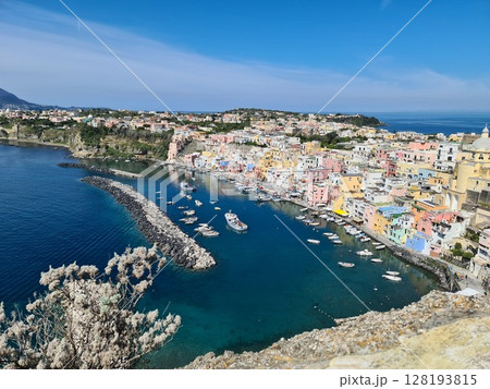 Panoramic view of Corricella a port on Procida, one of the Phlegraean Islands off the coast of Naples in southern Italy. Corricella is known for its vibrantly colorful housing 128193815
