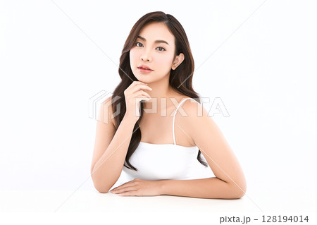 A beautiful young Asian woman with clean, fresh skin against a white background. Skincare, facial treatment, cosmetology, beauty, and spa. An elegant portrait of an Asian woman. A beautiful young Asian woman with clean, fresh skin against a white background. Skincare, facial treatment, cosmetology, beauty, and spa. An elegant portrait of an Asian woman. 128194014