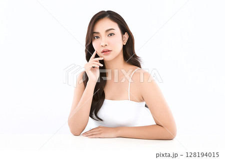 A beautiful young Asian woman with clean, fresh skin against a white background. Skincare, facial treatment, cosmetology, beauty, and spa. An elegant portrait of an Asian woman. A beautiful young Asian woman with clean, fresh skin against a white background. Skincare, facial treatment, cosmetology, beauty, and spa. An elegant portrait of an Asian woman. 128194015