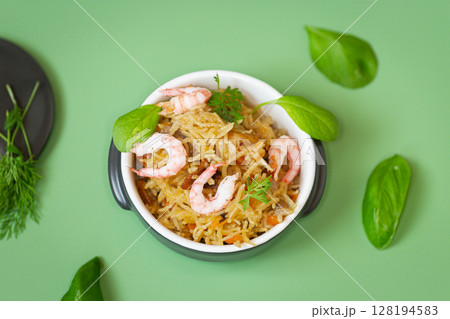 Homemade ceramic dish with vegetable rice and shrimps 128194583