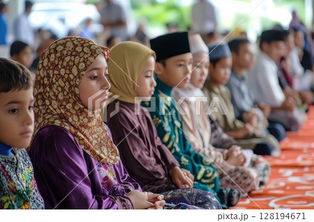 Group of young boys and girls in colorful traditional dress at Islamic event 128194671