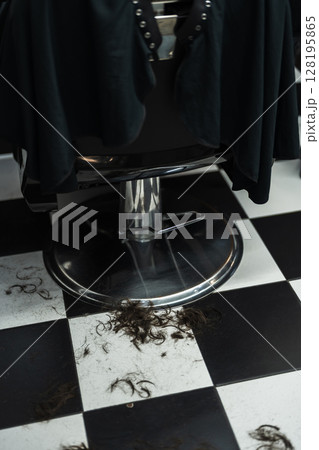 Hair transformations happening in a modern barbershop on a busy day 128195865