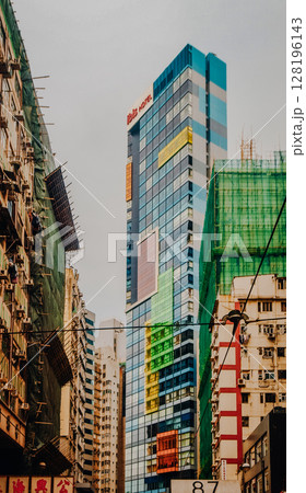 Dense High-Rise Residential Buildings In Hong Kong: Towering Urban Skyline With Layers Of Modern Apartments Under A Cloudy Sky In One Of The Worlds Most Populated Cities. Dense High-Rise Residential Buildings In Hong Kong: Towering Urban Skyline With Layers Of Modern Apartments Under A Cloudy Sky In One Of The Worlds Most Populated Cities. 128196143
