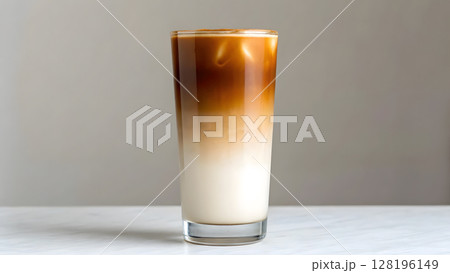 Delicious ombre iced coffee layered with milk served in a tall glass 128196149