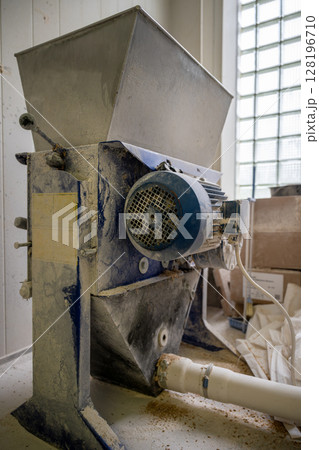 Close-up of malt mill machine used in beer brewing process at craft brewery 128196710
