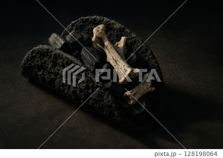 Creative dark themed taco with natural bone pieces and charcoal, arranged on textured surface for dramatic culinary presentation, AI Generative 128198064