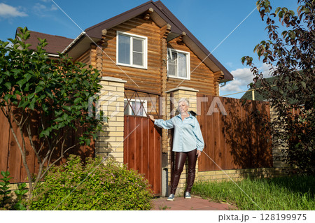 A Woman Standing at the Entrance of Her Home in a Beautiful and Picturesque Neighborhood A Woman Standing at the Entrance of Her Home in a Beautiful and Picturesque Neighborhood 128199975