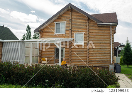 A Relaxing Outdoor Space Featuring a Woman Who Is Happily Enjoying a Refreshing Beverage A Relaxing Outdoor Space Featuring a Woman Who Is Happily Enjoying a Refreshing Beverage 128199988