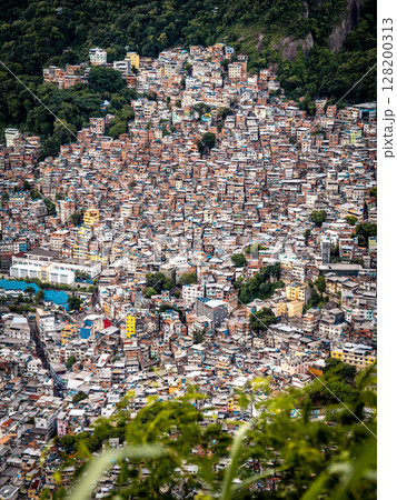 Aerial View Of Rocinha Favela In Rio De Janeiro: Dense Urban Landscape With Colorful Rooftops And Narrow Streets In The Largest Informal Settlement In Brazil Aerial View Of Rocinha Favela In Rio De Janeiro: Dense Urban Landscape With Colorful Rooftops And Narrow Streets In The Largest Informal Settlement In Brazil 128200313