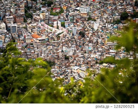Aerial View Of Rocinha Favela In Rio De Janeiro: Dense Urban Landscape With Colorful Rooftops And Narrow Streets In The Largest Informal Settlement In Brazil Aerial View Of Rocinha Favela In Rio De Janeiro: Dense Urban Landscape With Colorful Rooftops And Narrow Streets In The Largest Informal Settlement In Brazil 128200325