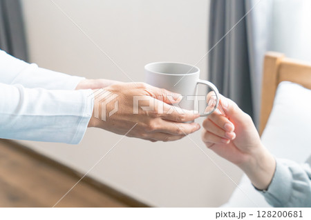 妊娠している娘に飲み物を渡す母 128200681