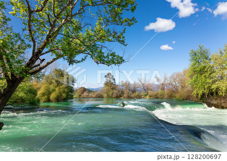 Beautiful natural landscape of Manavgat waterfall in national park on sunny spring day. Unique azure water color with splashes, Side, Antalya,Turkey. High quality photo 128200697