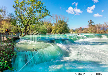 Beautiful natural landscape of Manavgat waterfall in national park on sunny spring day. Unique azure water color with splashes, Side, Antalya,Turkey. High quality photo 128200698