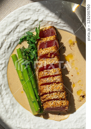 Grilled sliced tuna with asparagus and sesame Grilled sliced tuna with asparagus and sesame 128200760