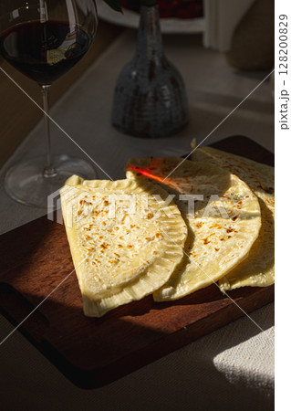 Qutab flatbreads on board with glass of red wine Qutab flatbreads on board with glass of red wine 128200829