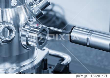 The multi axis CMM machine measuring the aluminum housing parts in the light blue scene. 128201471