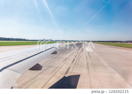 View from the airplane window during takeoff at Sheremetyevo airport at summer View from the airplane window during takeoff at Sheremetyevo airport at summer 128202215