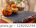 ハロウィンのかぼちゃと古い手帳と古書 128202294