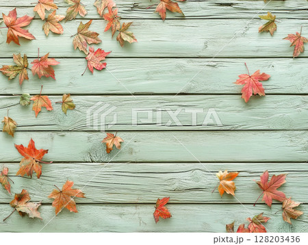 Distressed blue wooden background adorned with vibrant autumn maple leaves. Distressed blue wooden background adorned with vibrant autumn maple leaves. 128203436