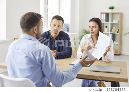 Married Couple Meeting With Financial Consultant Or Real Estate Agent In Office Married Couple Meeting With Financial Consultant Or Real Estate Agent In Office 128204385