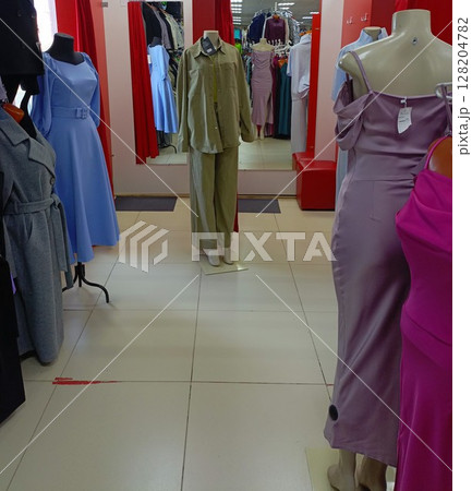 Mannequins with women's clothes in a store in light colors representing retail and shopping 128204782