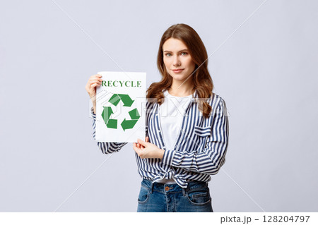 Recycling Concept. Eco-Activist Holding Placard With Green Recycle Sign Icon, Positive Millennial Nature-Friendly Woman Posing On Light Studio Background With Copy Space 128204797