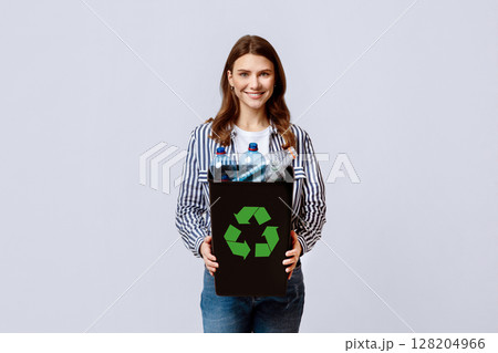 Beautiful Young Lady Carrying Container With Empty Plastic Bottles Ready For Recycling, Millennial Nature-Lover Woman Enjoying Zero-Waste Living, Standing On Light Studio Background, Copy Space 128204966