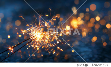 夏の夜に燃える二本の線香花火のクローズアップ、青い背景に広がる火花 夏の夜に燃える二本の線香花火のクローズアップ、青い背景に広がる火花 128205595