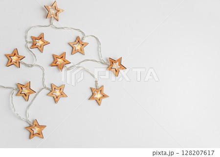 Christmas holidays background with Christmas lights on white background. Top view 128207617