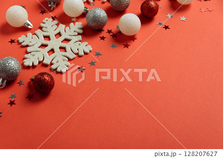 Red Christmas background with snowflakes and glitter ornaments. Christmas and Happy New Year celebration concept. Top view 128207627