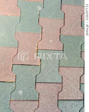 Rubber pavement in a top-down style, in red-brown and grey-green colors, representing urban flooring and safety Rubber pavement in a top-down style, in red-brown and grey-green colors, representing urban flooring and safety 128207712
