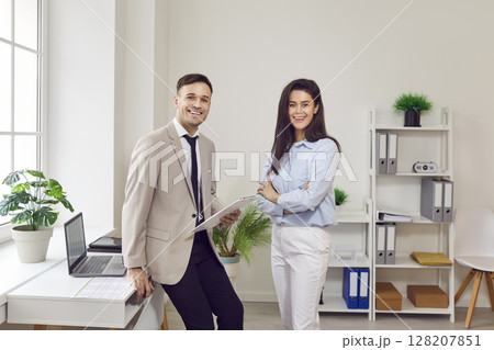 Happy colleagues meet in office room chatting enjoy friendly conversation, smiling business mates 128207851