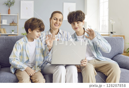 Happy Mother With Two Sons Having Online Video Call On Laptop At Home 128207858