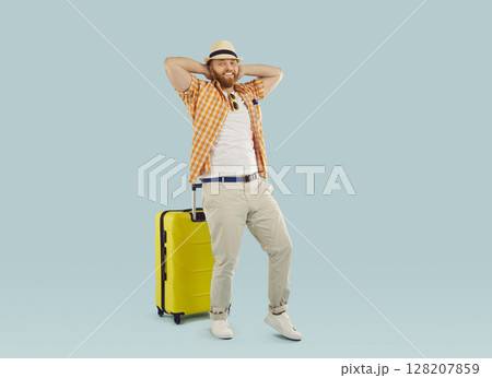 Happy tourist, traveler man holiday excursionist with yellow wheel suitcase bag ready for trip  128207859