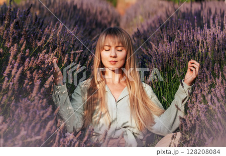 Woman Practicing Meditation and Breathing Exercises in Lavender 128208084