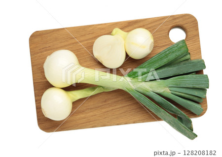 Green onion on cutting board isolated on white background. Green onion on cutting board isolated on white background. 128208182