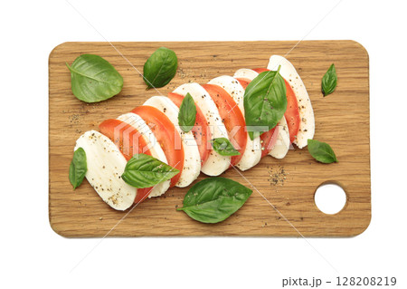 Mozzarella cheese with green basil leaves and tomato on cutting board isolated on white background Mozzarella cheese with green basil leaves and tomato on cutting board isolated on white background 128208219