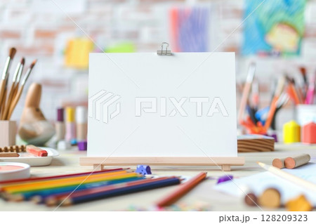 Blank Canvas with Colorful Toys, Pencils, and Plant on Wooden Table in Kid's Playroom 128209323