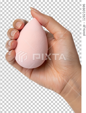 Hand holding soft pink makeup sponge isolated on transparent background, beauty blender, cosmetic tool, flawless foundation application 128210696