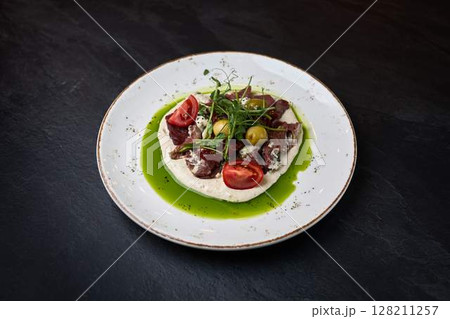 Gourmet beef tartare with creamy hummus base Gourmet beef tartare with creamy hummus base 128211257