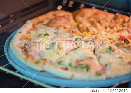 Pizza in a ceramic plate for serving. 128212913