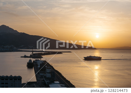 View of a ferry at sunset entering the port of Ceuta 128214473