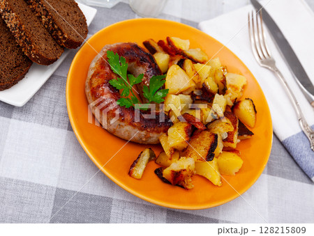 Grilled sausage garnished with potato prepared for dinner 128215809
