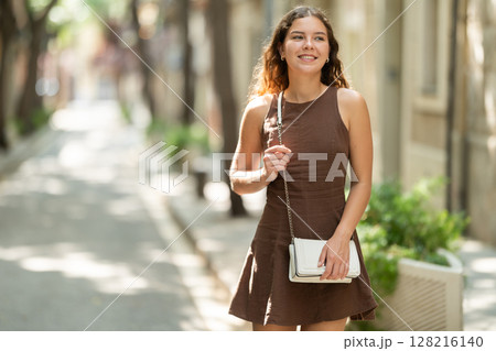 Woman walking in the park in summer Woman walking in the park in summer 128216140