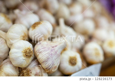 Garlic in a crate for sale in a store 128216173