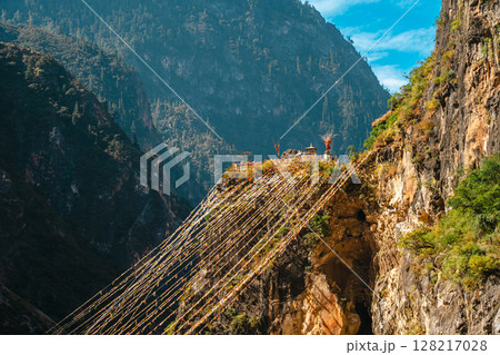 Prayer Flags Crossing a Deep Balagezong Canyon in Shangri-La 128217028