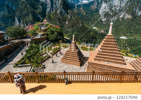 Tibetan Stupa with Prayer Flags and Snowy Peaks in Balagezong, Shangri-La, Yunnan. 128217040