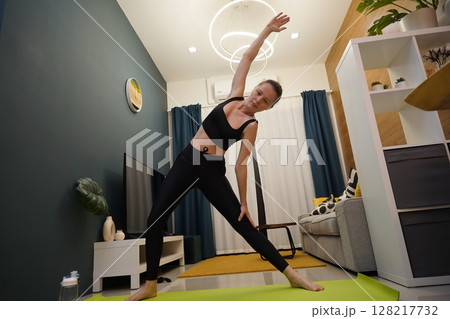 A young woman have a joyfully yoga practice  128217732