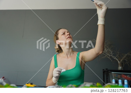 The process of making the art decor of epoxy resin, natural stones and moss 128217763