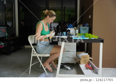 The process of making the art decor of epoxy resin, natural stones and moss 128217765